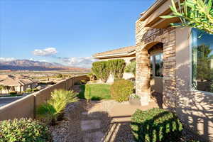 View of side yard featuring a mountain view, private entry and a patio