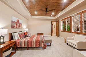 Carpeted bedroom with wooden ceiling, ornamental molding, a raised ceiling, recessed lighting, and ceiling fan