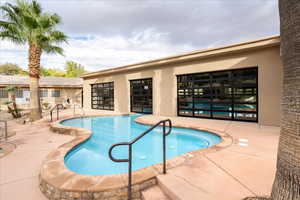 Community pool with a patio