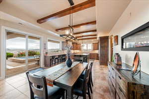 Dining space with beam ceiling and light tile patterned floors