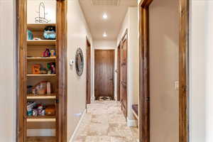 Corridor with recessed lighting and light tile patterned flooring