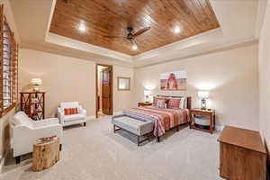 Bedroom with a raised ceiling, wood ceiling, carpet, recessed lighting, and crown molding