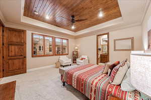 Bedroom with wood ceiling, a tray ceiling, crown molding, carpet, and recessed lighting