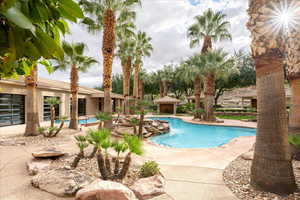Community pool featuring a patio area and a gazebo