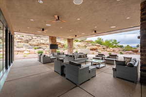 View of club house patio / terrace featuring ceiling fan and an outdoor hangout area