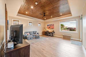 Casita room featuring a raised ceiling, wood ceiling, light wood finished floors, recessed lighting, a ceiling fan and private exterior entrance
