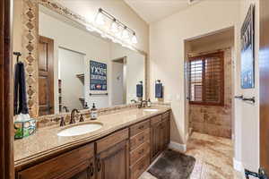 Guest Suite Full bathroom with double vanity and light tile patterned floors