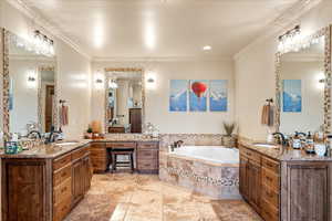 Primary bathroom with two vanities, a bath, crown molding, and light tile patterned floors