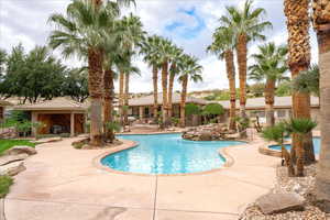 Community pool with a patio area, a hot tub, and a gazebo