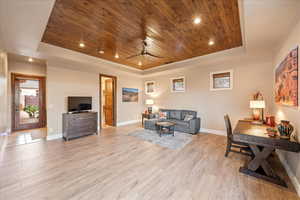 Casita area featuring a tray ceiling, wood ceiling, recessed lighting, a ceiling fan, light wood-style flooring and private exterior entrance