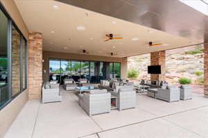 View of club house patio / terrace with an outdoor living space and ceiling fan