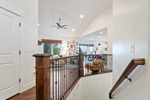 Corridor featuring recessed lighting, dark wood-style flooring, an upstairs landing, and high vaulted ceiling