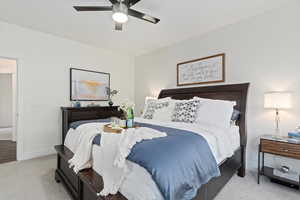 Bedroom featuring light colored carpet and ceiling fan