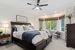 Bedroom featuring light carpet, a ceiling fan, and recessed lighting