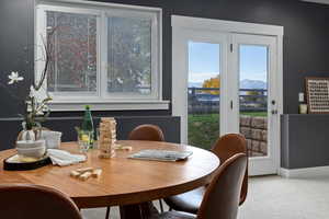 Dining area featuring carpet floors and a mountain view