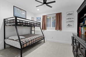 Bedroom with light colored carpet, ceiling fan, and recessed lighting