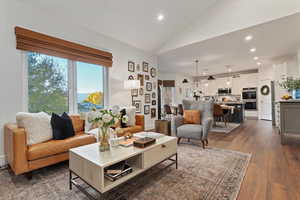 Living area featuring recessed lighting, lofted ceiling, and dark wood-style floors