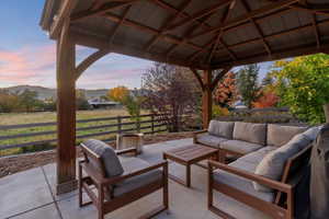 View of patio / terrace featuring an outdoor living space, a mountain view, and a gazebo
