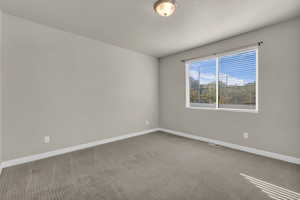 Spare room featuring carpet flooring