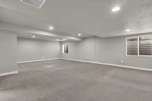 Below grade area featuring recessed lighting and carpet floors
