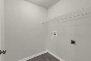 Washroom featuring dark tile patterned flooring, washer hookup, and electric dryer hookup