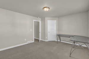 Unfurnished office featuring carpet floors and baseboards