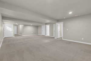 Empty room featuring recessed lighting and carpet floors