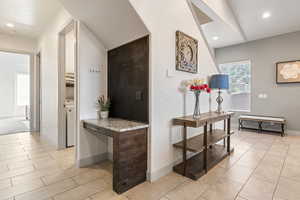 Hallway with recessed lighting and light tile patterned flooring