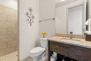 Full bathroom featuring vanity, light tile patterned floors, and a tile shower