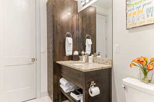 Half bath featuring vanity and light tile patterned floors