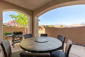 View of patio with a mountain view, outdoor dining area, and grilling area