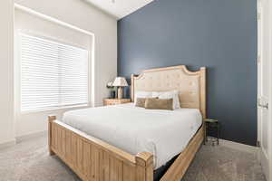 Carpeted bedroom featuring baseboards