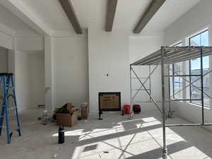 Living room with recessed lighting, wrapped beams and fireplace