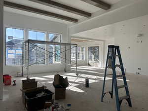 Living room with recessed lighting, wrapped beams and fireplace