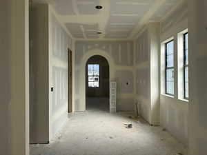 Unfurnished room with arched walkways