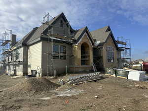 View of front of home featuring a shingled roof