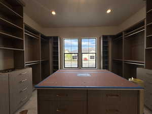 Primary closet with built-in cabinets