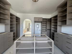 Walk in closet with arched walkways