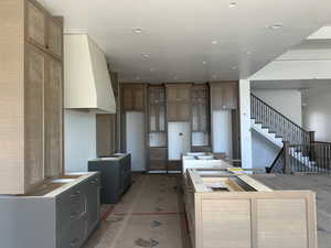 Dual tone kitchen featuring a center island, dual tone cabinetry, and recessed lighting