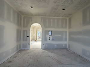 Empty room featuring arched walkways