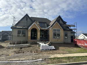 Property in mid-construction featuring a shingled roof