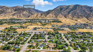 View of property location featuring nearby suburban area and a mountain backdrop