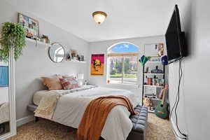 Carpeted bedroom featuring a textured ceiling
