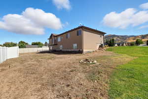 View of property exterior with a mountain view and a fenced backyard