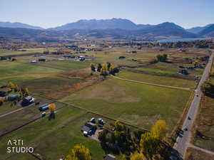 Aerial view of property's location with rural landscape and a mountainous background