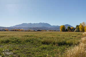 View of mountain backdrop featuring rural landscape
