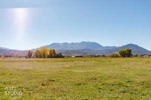 View of mountain backdrop featuring rural landscape