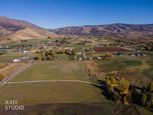 Aerial view of property's location featuring rural landscape and a mountain backdrop