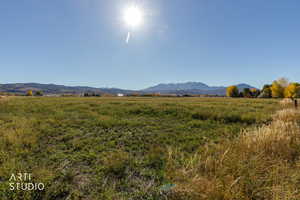 View of mountain backdrop featuring rural landscape