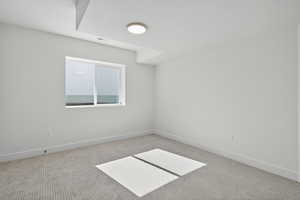 Spare room featuring carpet flooring